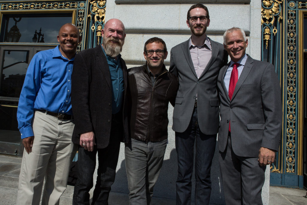 Officials gathered on the steps of San Francisco City Hall to announce the launch of the Generations HIV Online Video Archive and included, from left, Vincent Fuqua from the health department; Tez Anderson, of Let's Kick ASS (AIDS Survivor Syndrome); Marc Smolowitz, co-founder of the HIV Story Project; Supervisor Scott Wiener; and John Cunningham, of the National AIDS Memorial Grove. Photo: Khaled Sayed