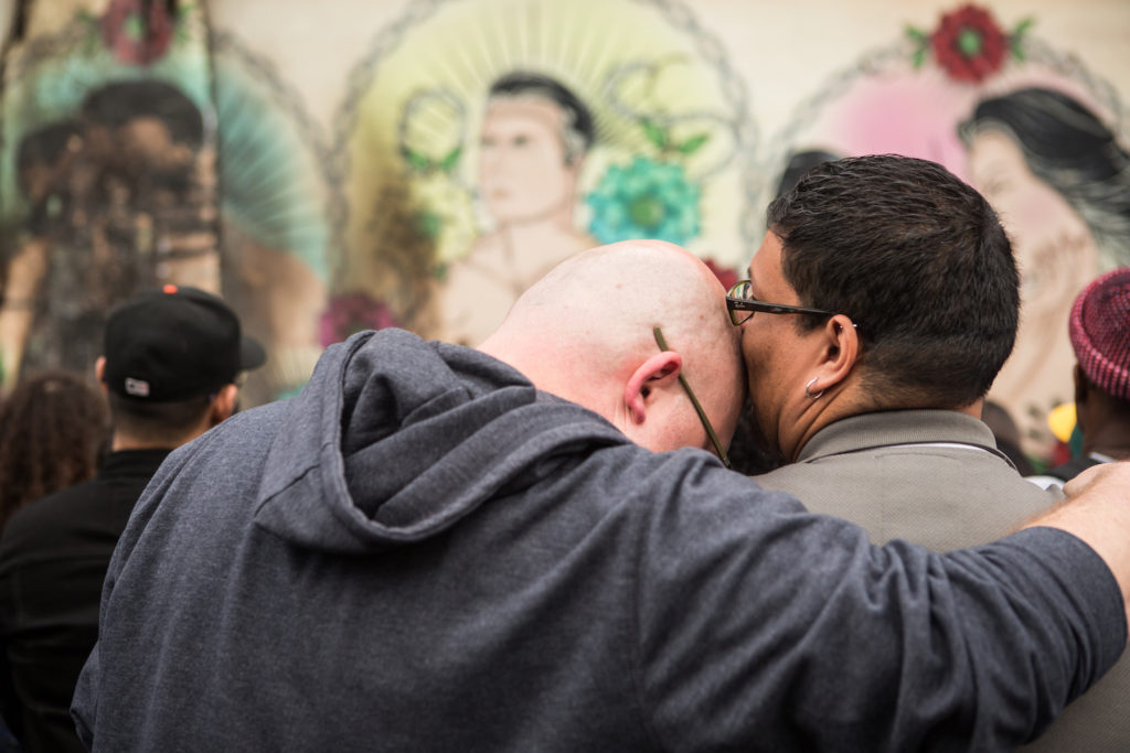 A couple mourns the damage to a vandalize LGBT-themed mural. (Photo by Khaled Sayed/Bay News Rising)